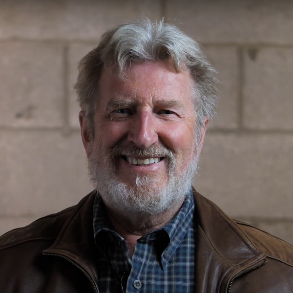 A smiling photo of artist Tom Clark.